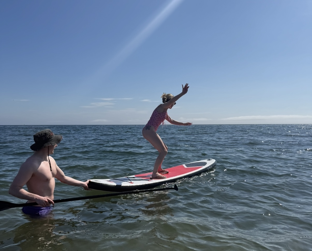 Emily paddleboarding on the ocean